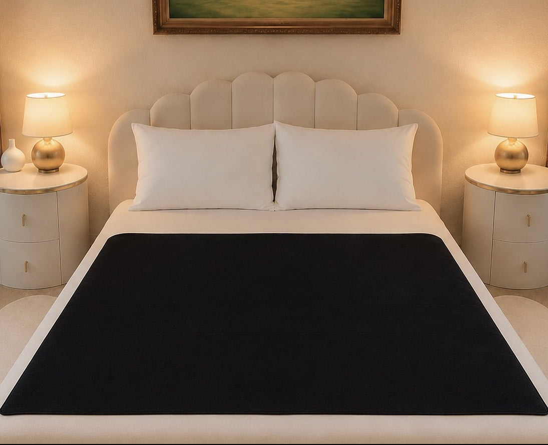 Reversible black active-dry side of the Moonstone organic cotton Venus Mat — wicks fluid instantly, breathable, PFAS-free waterproofing made in the USA
