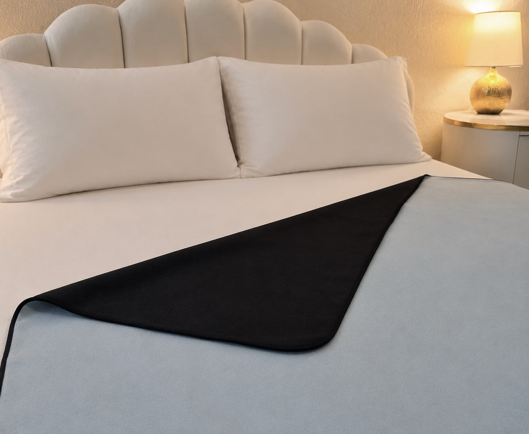 Aquamarine organic cotton Venus Mat folded to show black active-dry backing — reversible waterproof sex mat, certified organic cotton, PFAS-free