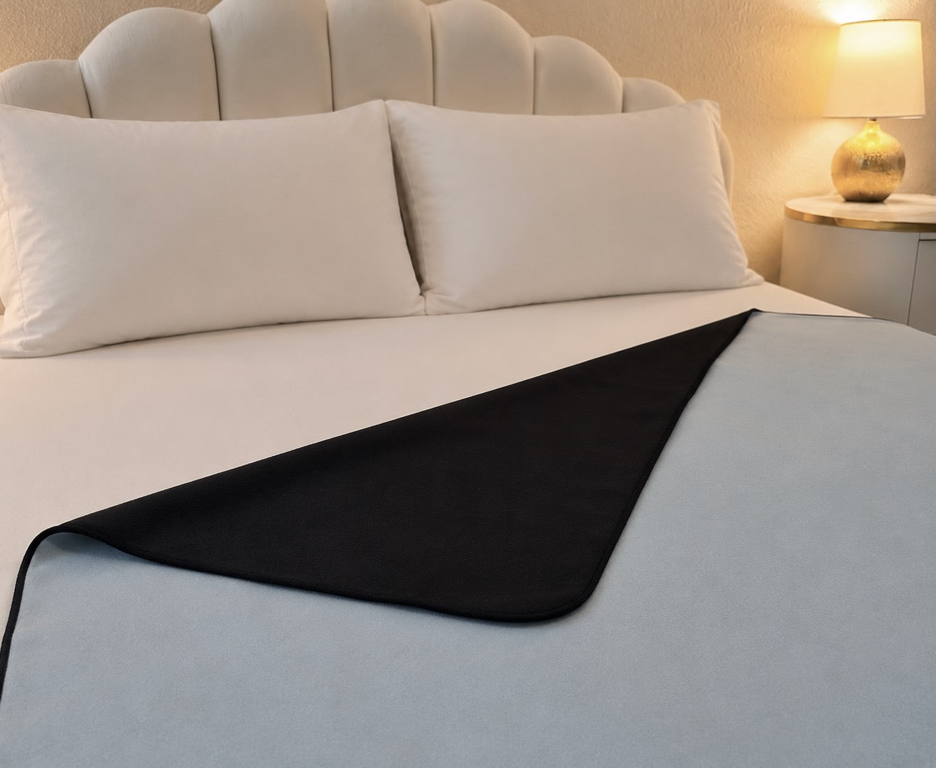 Aquamarine organic cotton Venus Mat folded to show black active-dry backing — reversible waterproof sex mat, certified organic cotton, PFAS-free