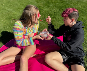 a man and a woman eating on so much more than a toy waterproof bed mat