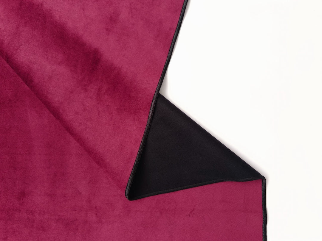 Folded velvet Ruby Red Venus Mat with ultra-absrobet sleek black backing protects mattress