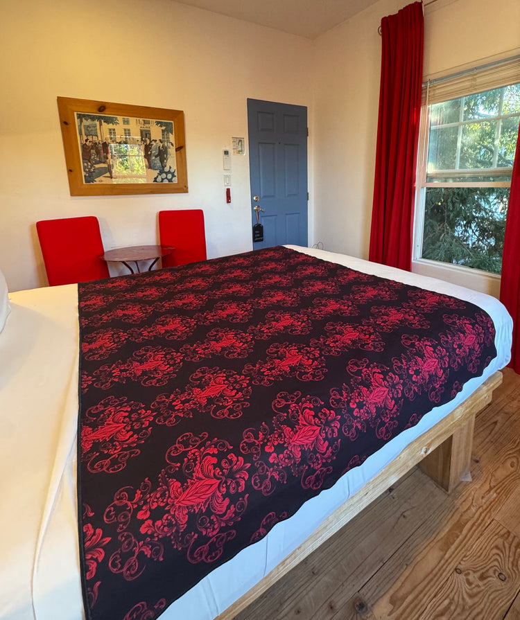 Repeated crimons royal motif on Her Majesty Crimson Venus Mat waterproof bed mat