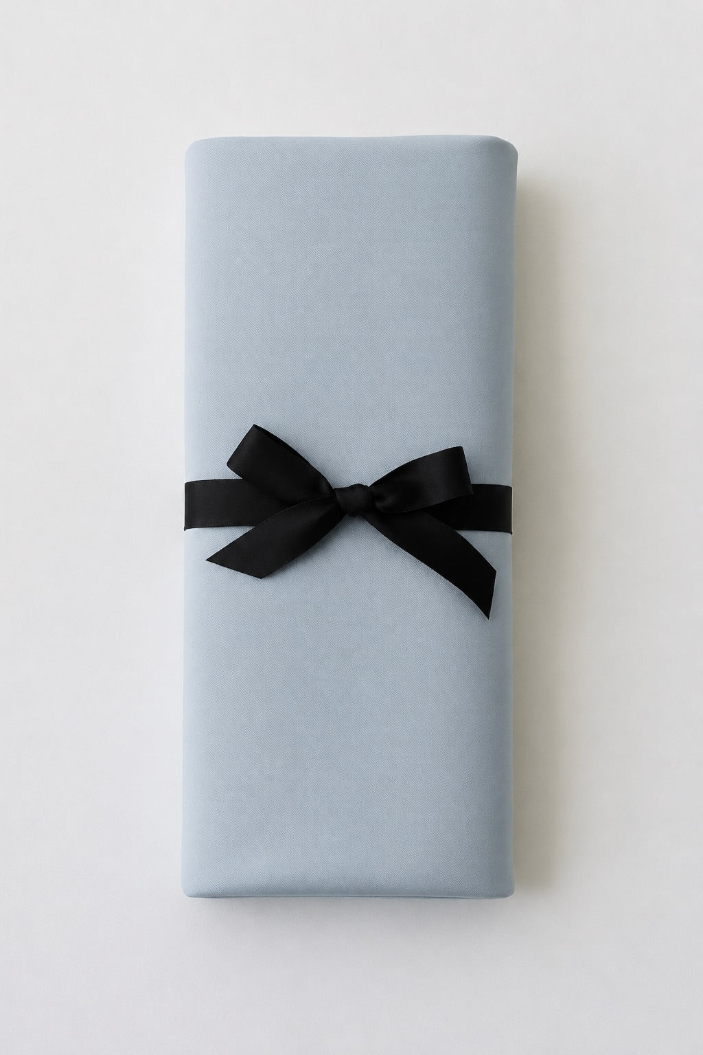 Aquamarine organic cotton Venus Mat folded with black ribbon — organic cotton waterproof sex mat, perfect gift for menarche, postpartum or pleasure
